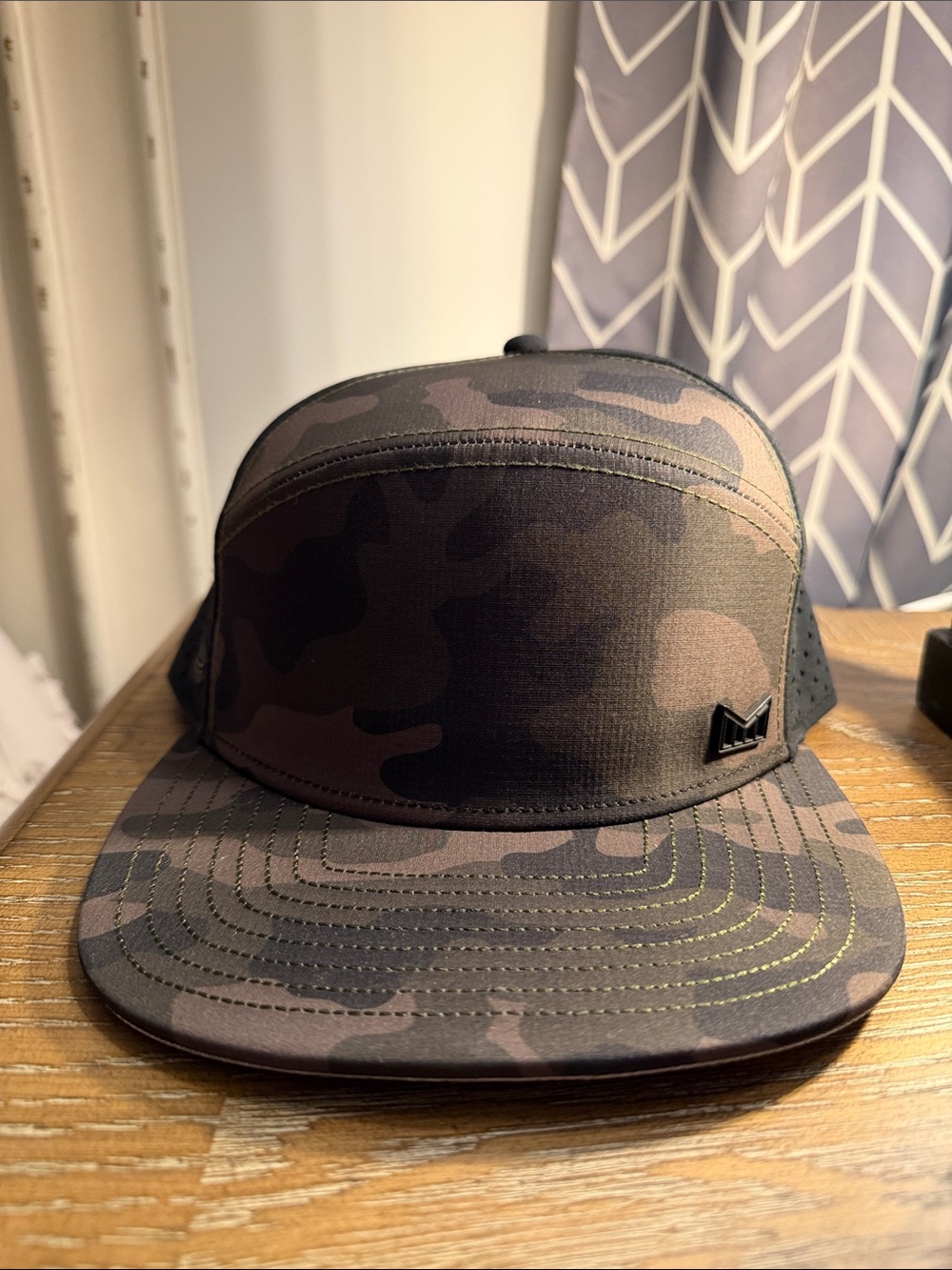 Melin Camouflage Trucker Cap with Subtle Metal Logo